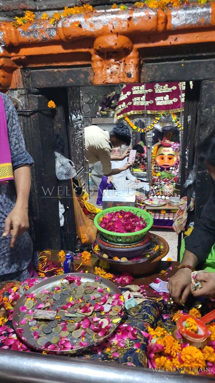 Kal Bhairav Temple — Inside the sanctum — flowers, coins and offerings before the deity